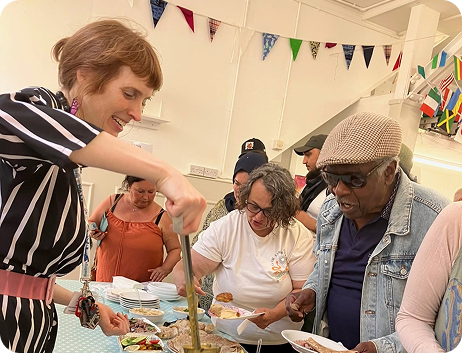 A member of HVA staff serving food at an event