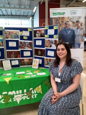 Macmillan Cancer Support stall at Tescos with team member smiling