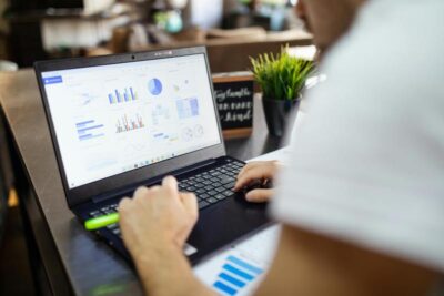 A laptop displaying charts and data