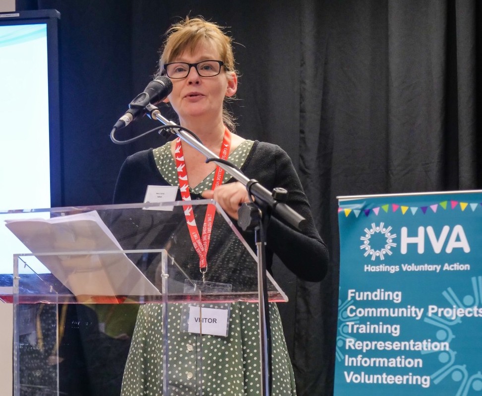 A trustee speaks at a lectern at the Hastings ADM