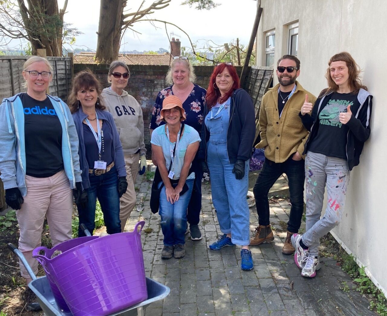 A group of people volunteering at a garden